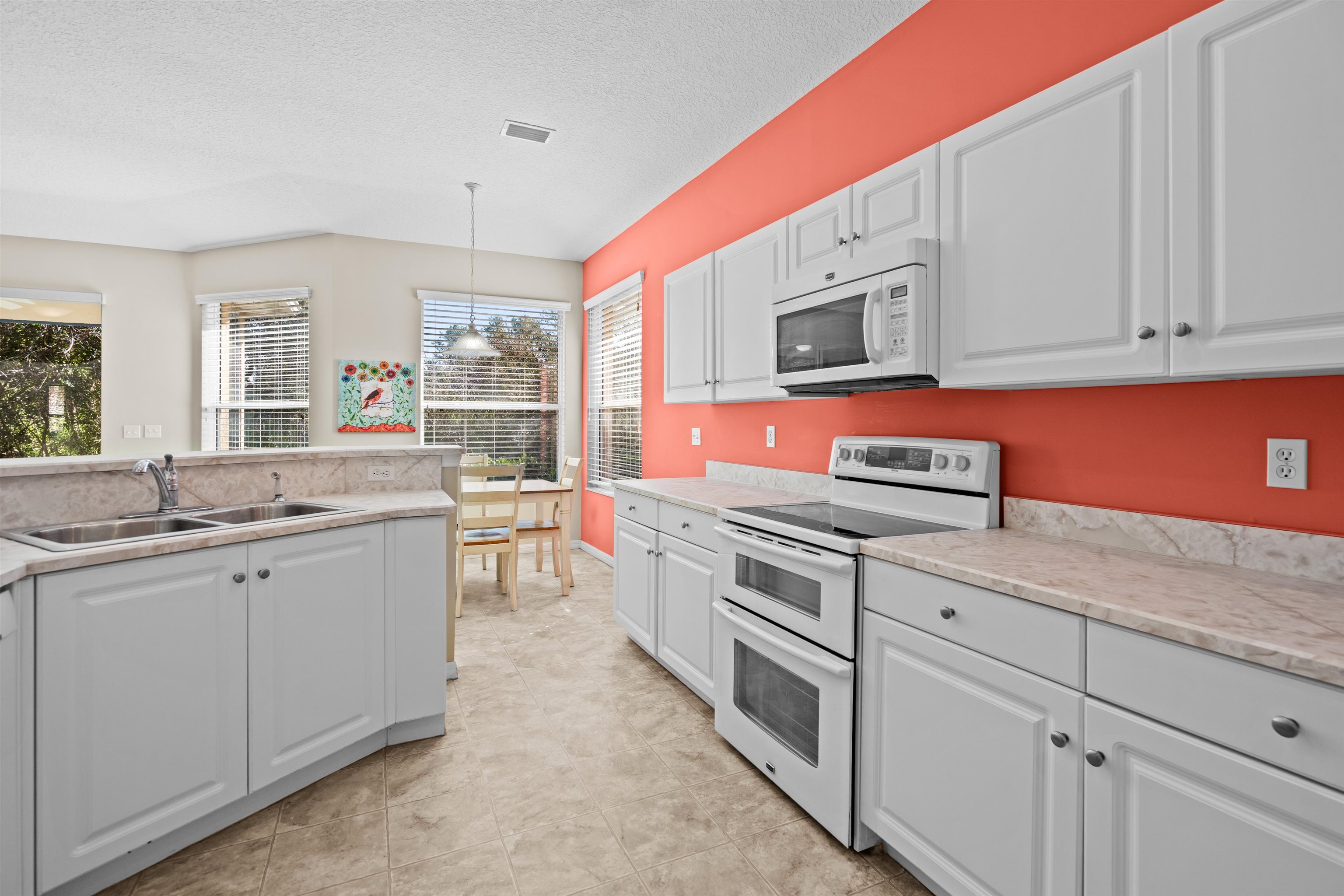 660 Casa Fuerta Lane St. Augustine, FL 32080 - Photo 16 of 52 a kitchen with stainless steel appliances granite countertop a sink and dishwasher stove with wooden cabinets