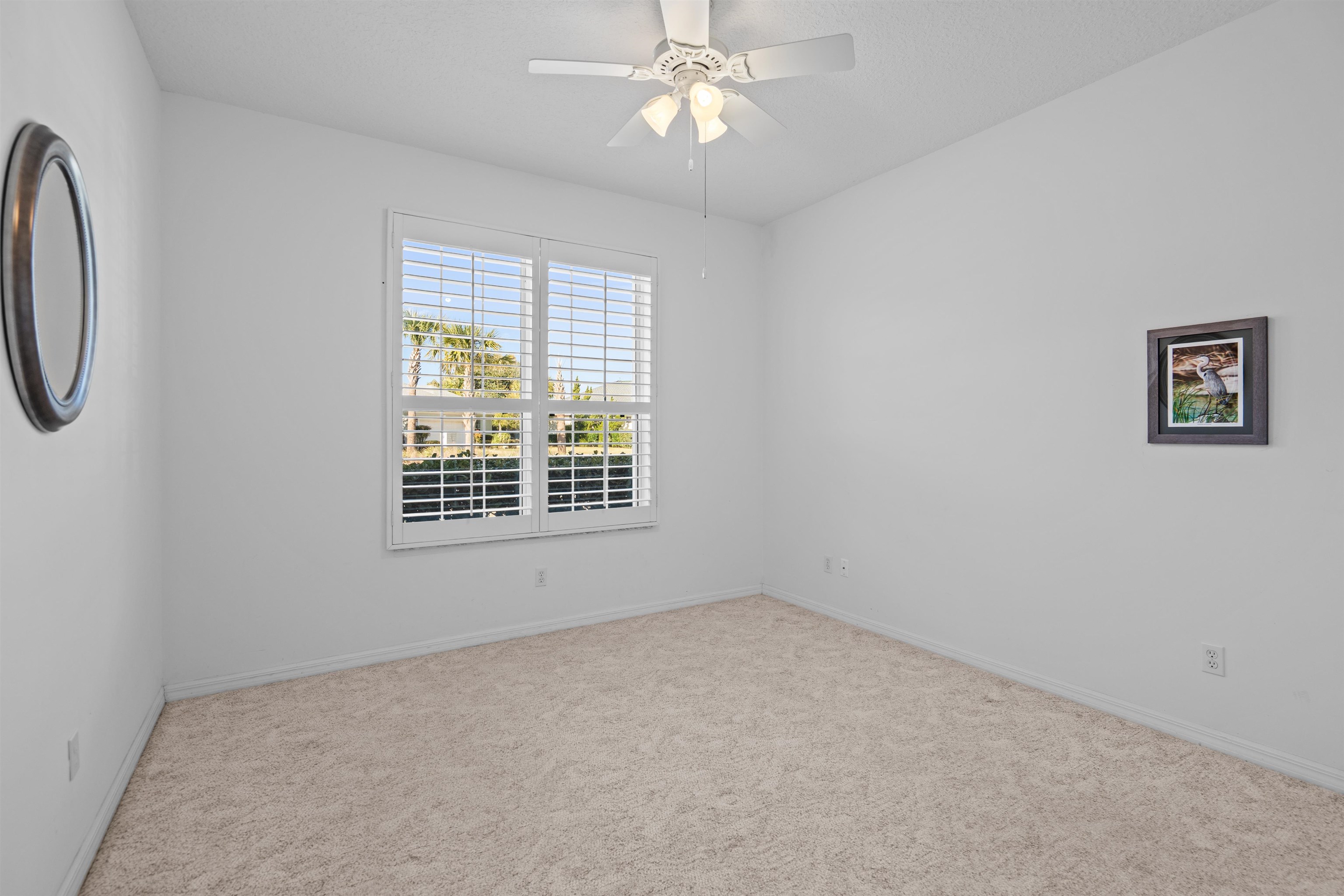 660 Casa Fuerta Lane St. Augustine, FL 32080 - Photo 19 of 52 wooden floor in an empty room with a window