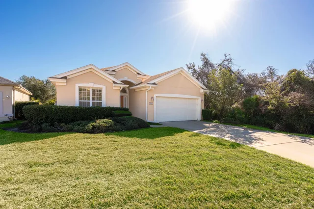 a living room with furniture a fireplace and a chandelier