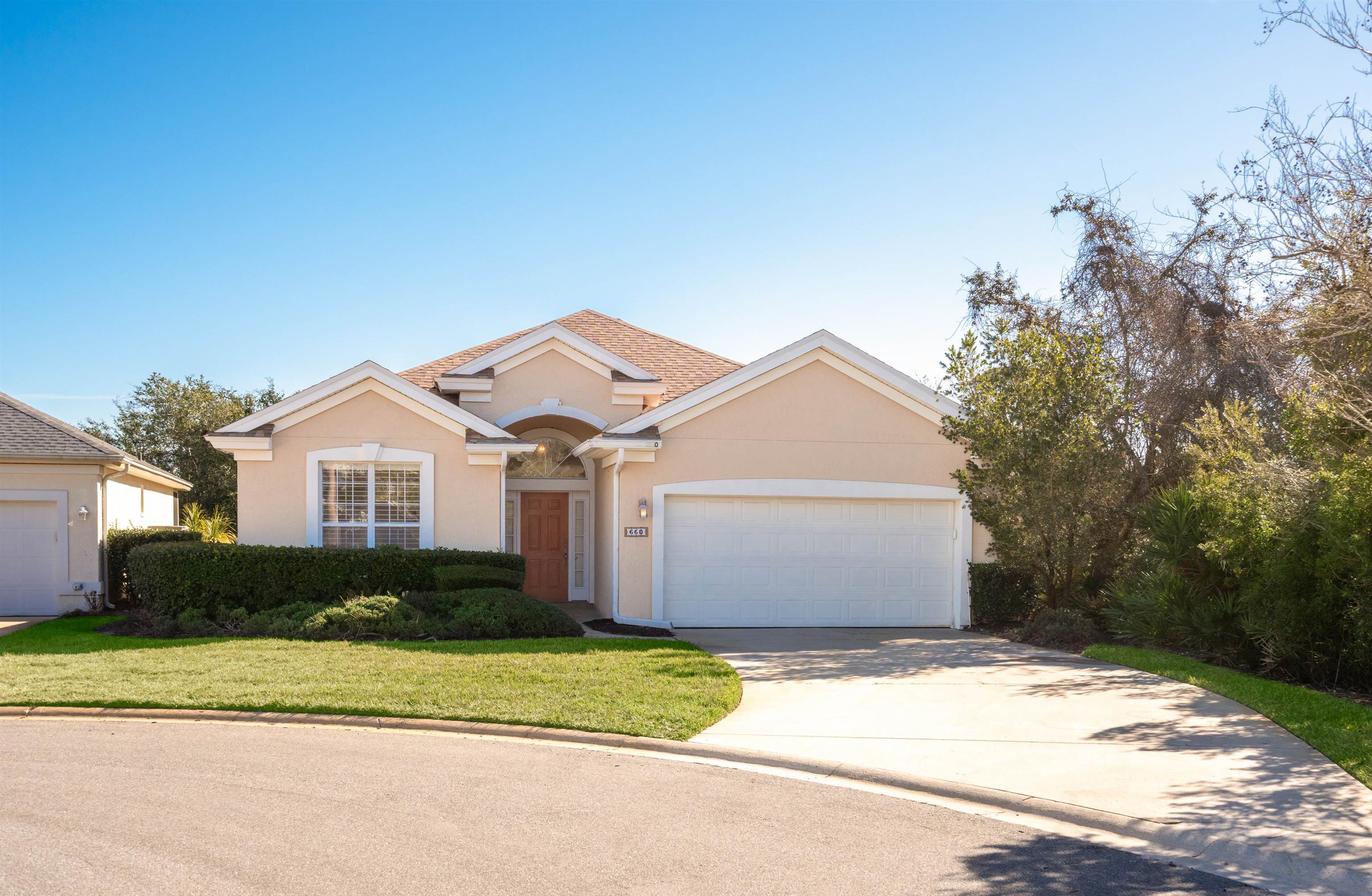 660 Casa Fuerta Lane St. Augustine, FL 32080 - Photo 3 of 52 View of front of home with stucco siding, concrete driveway, a front lawn, and an attached garage