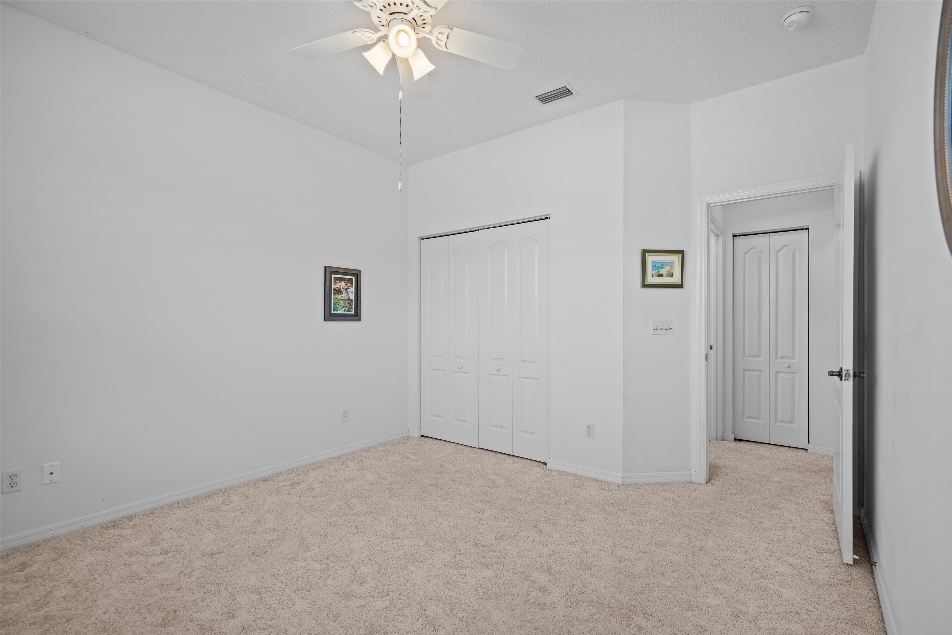 660 Casa Fuerta Lane St. Augustine, FL 32080 - Photo 47 of 52 Unfurnished bedroom with light colored carpet, a closet, and ceiling fan