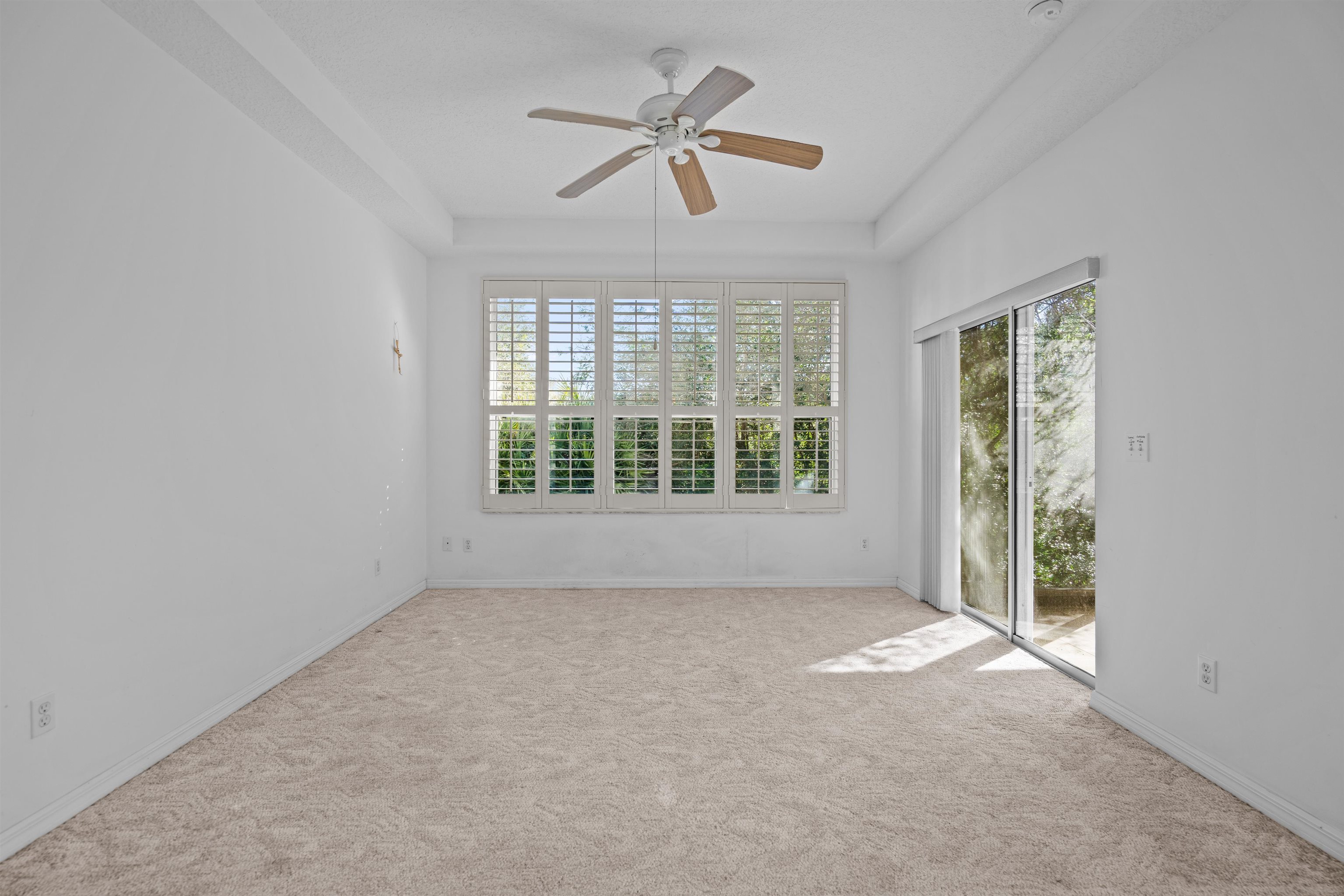 660 Casa Fuerta Lane St. Augustine, FL 32080 - Photo 50 of 52 Carpeted spare room with ceiling fan and a tray ceiling