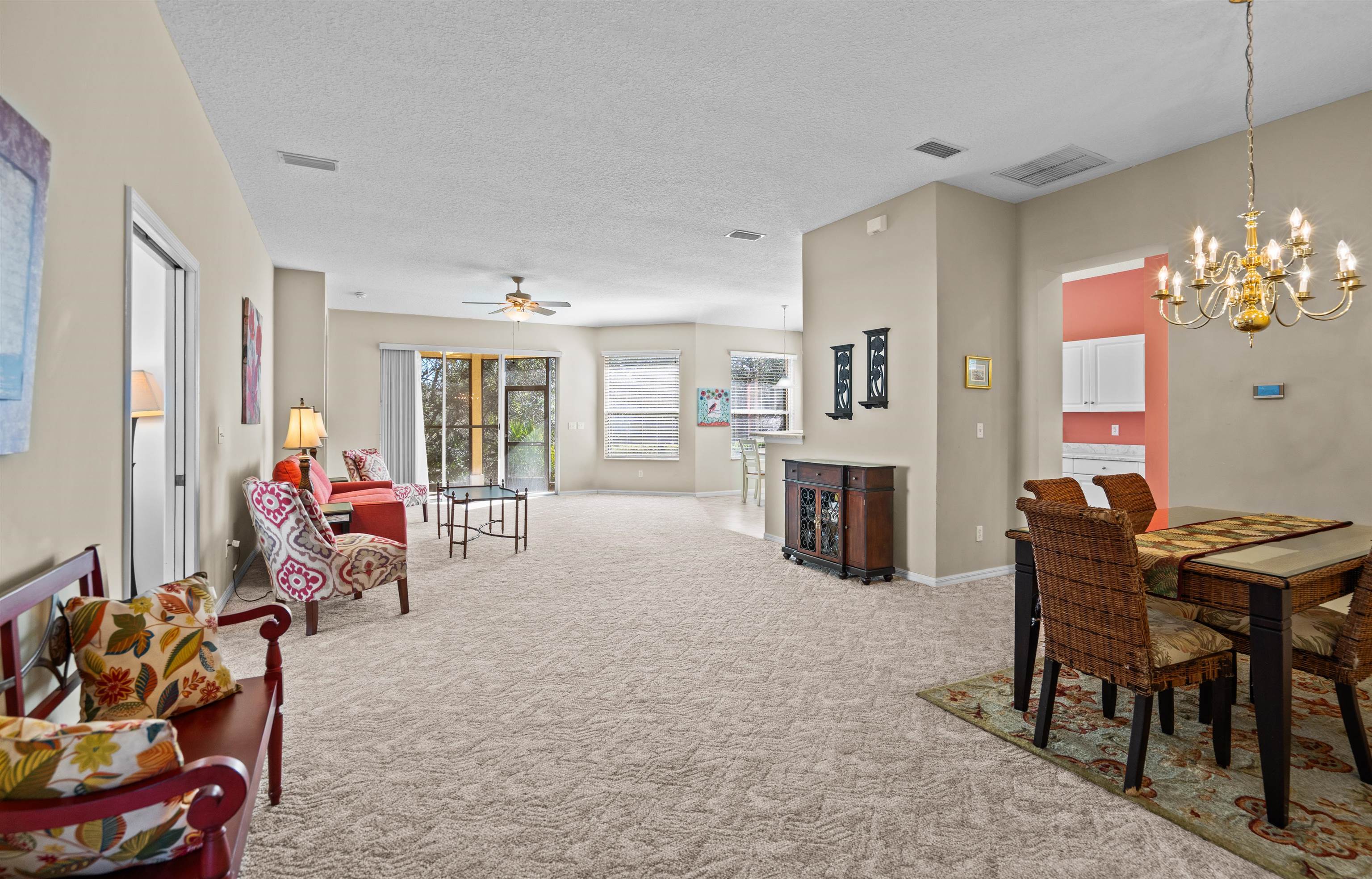 660 Casa Fuerta Lane St. Augustine, FL 32080 - Photo 6 of 52 a living room with furniture a fireplace and a chandelier