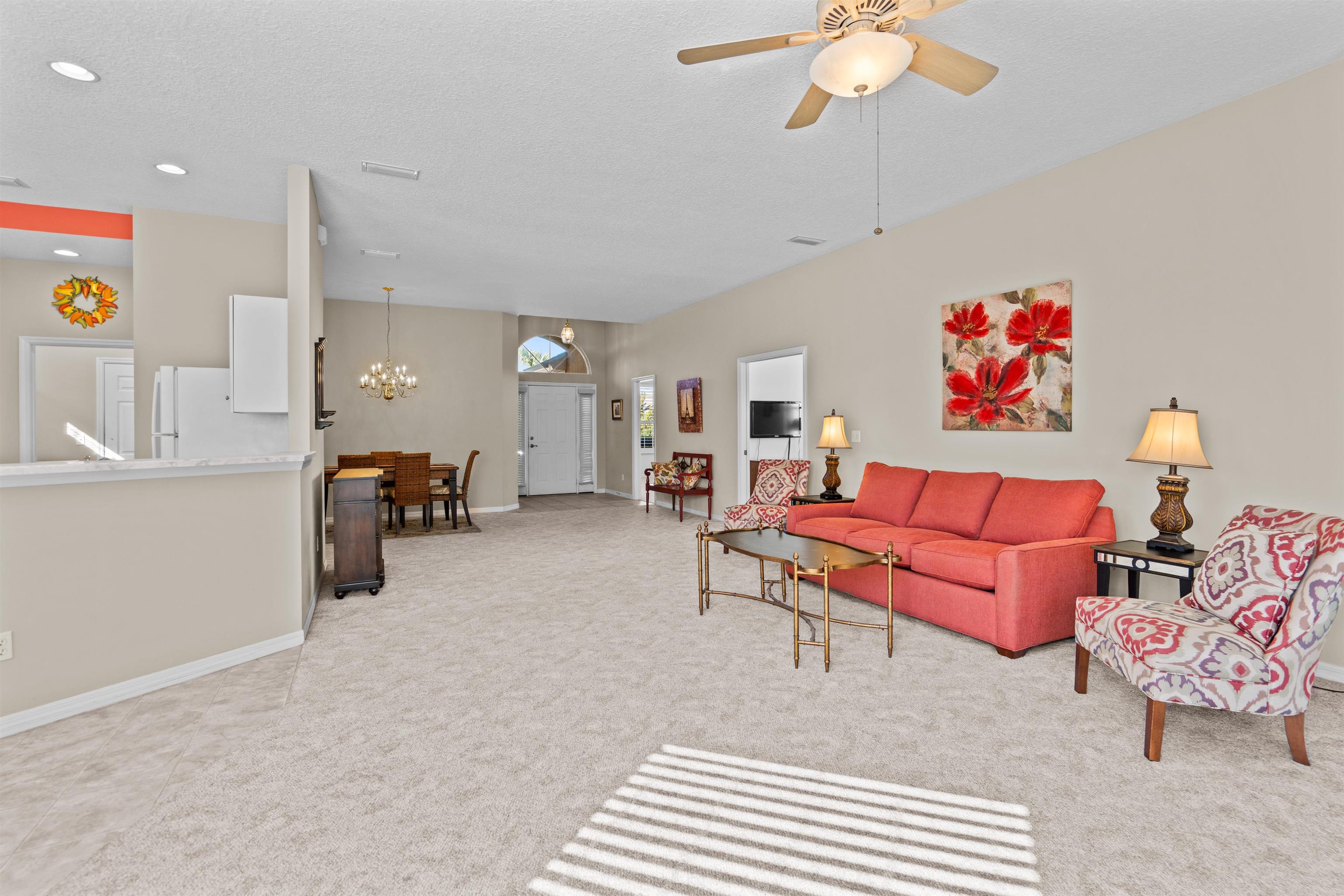 660 Casa Fuerta Lane St. Augustine, FL 32080 - Photo 9 of 52 a living room with furniture and a chandelier