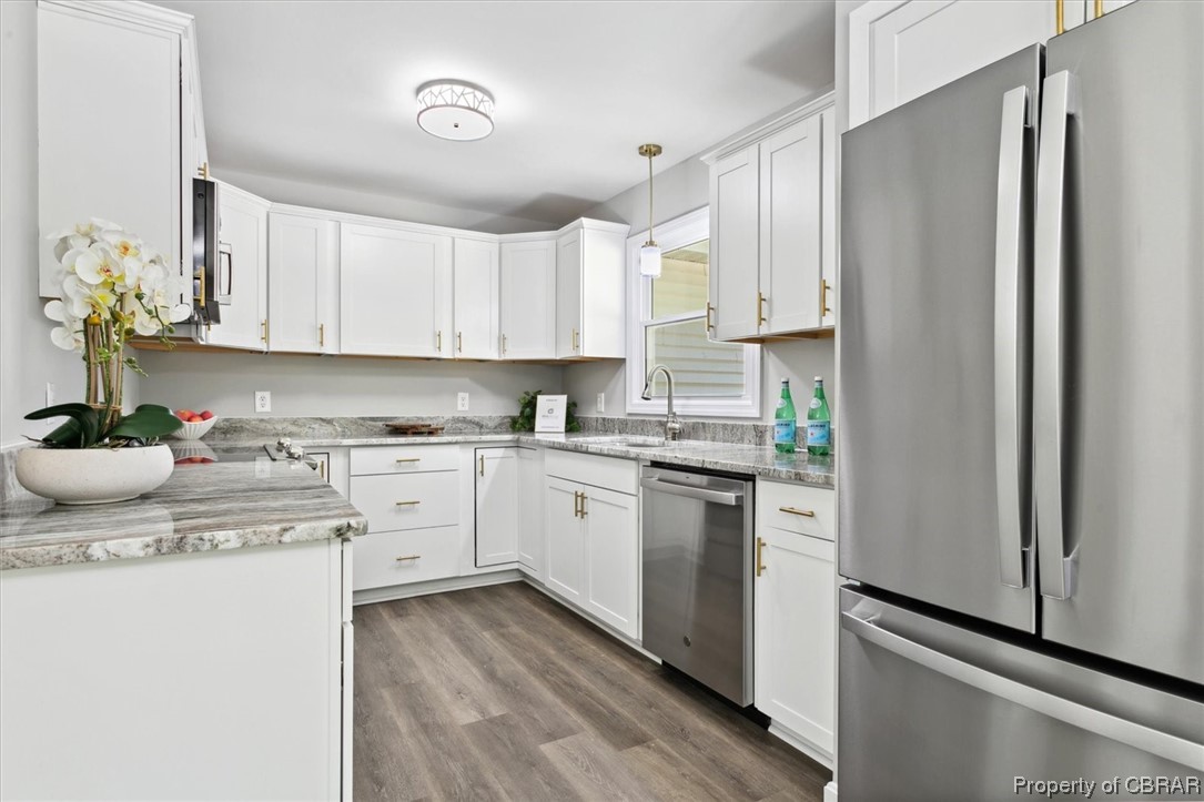 8636 Diascund Road Lanexa, VA 23089 - Photo 6 of 50 Kitchen featuring decorative light fixtures, white cabinets, appliances with stainless steel finishes, hardwood floors, and light stone countertops