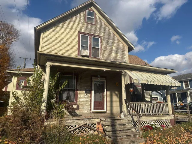 a front view of a house with a garden