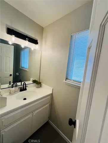 a bathroom with a sink and mirror