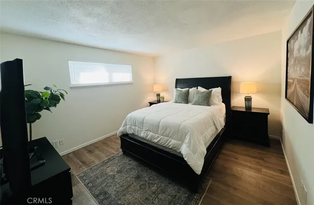 a bed room with a bed and a potted plant