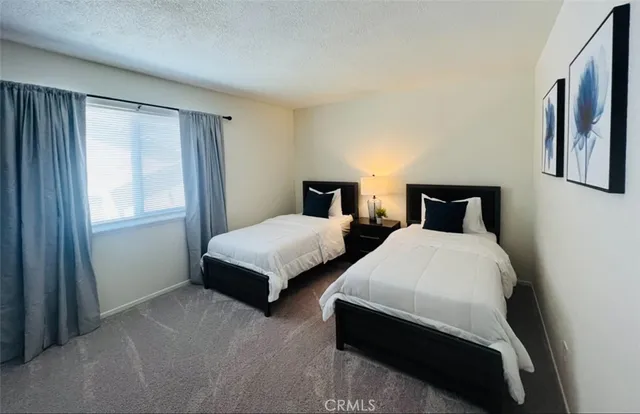 a bedroom with two beds and a window