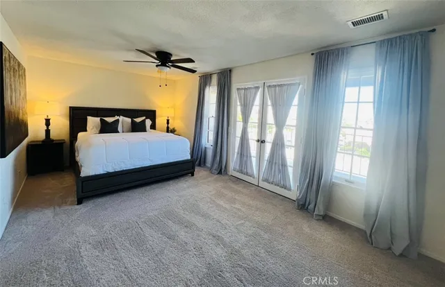 a spacious bedroom with a bed and a window