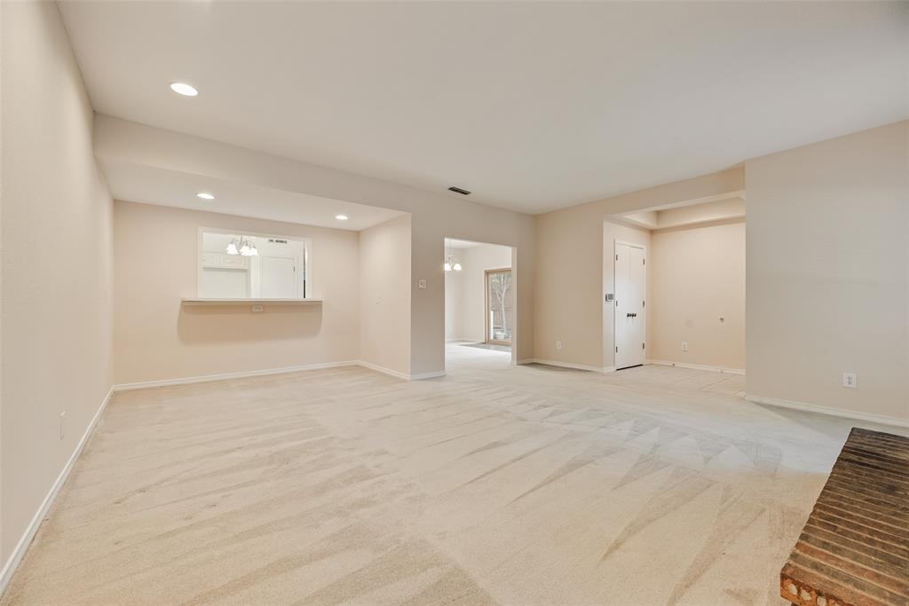 4988 Thunder Road Dallas, TX 75244 - Photo 6 of 32 Spacious room featuring a brick fireplace, neutral carpet, and recessed lighting