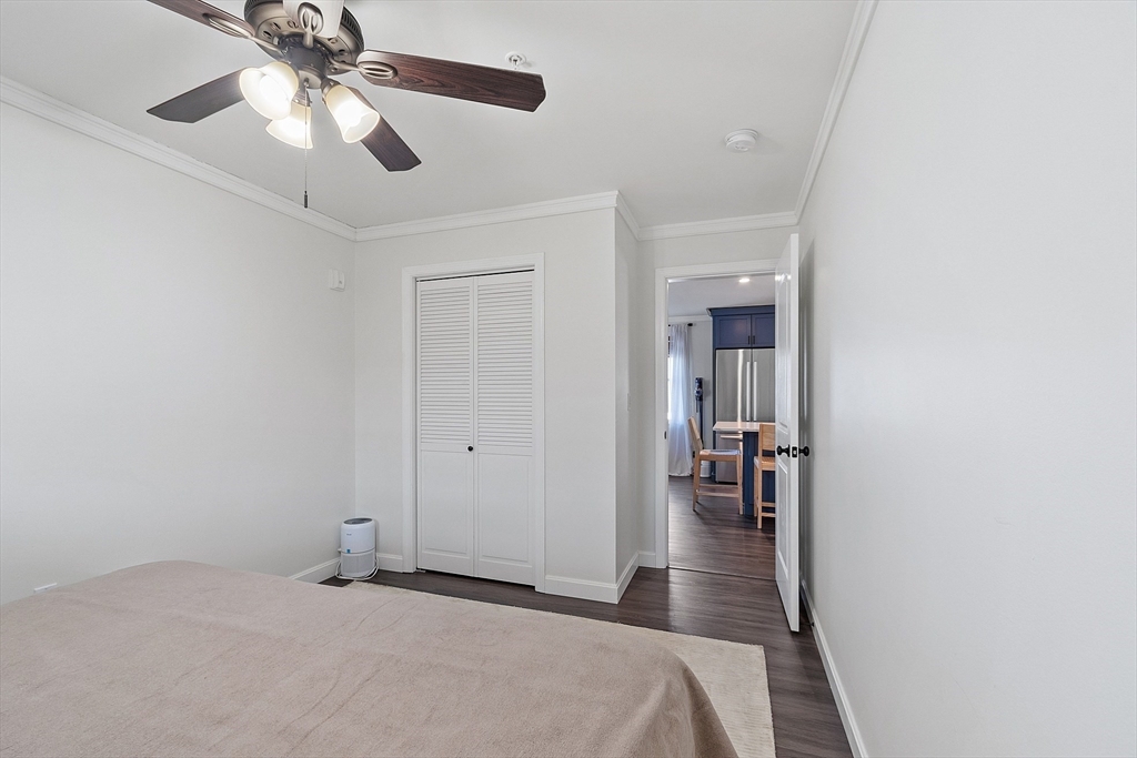 20 Cable Avenue, Unit 5 Salisbury, MA 01952 - Photo 16 of 23 a bedroom with a bed and a chandelier