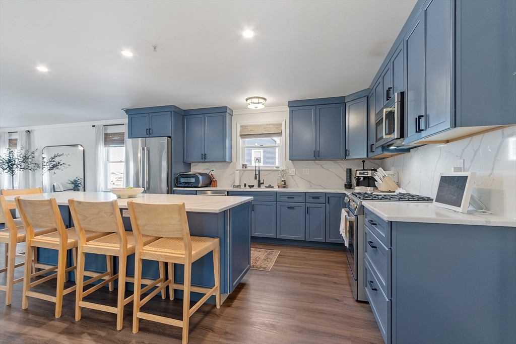 20 Cable Avenue, Unit 5 Salisbury, MA 01952 - Photo 4 of 23 a kitchen with granite countertop a sink stainless steel appliances and cabinets