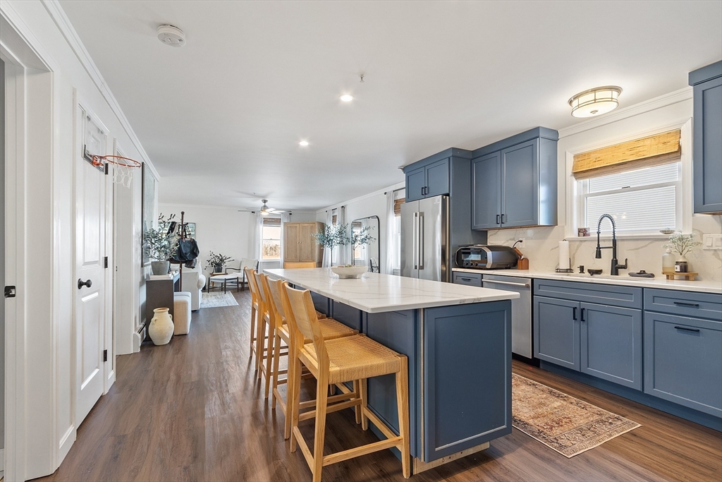 20 Cable Avenue, Unit 5 Salisbury, MA 01952 - Photo 7 of 23 a kitchen with wooden cabinets and center island
