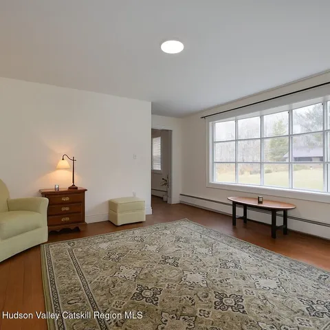 a bedroom with furniture and a window