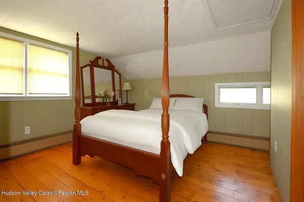 a bedroom with a bed and window