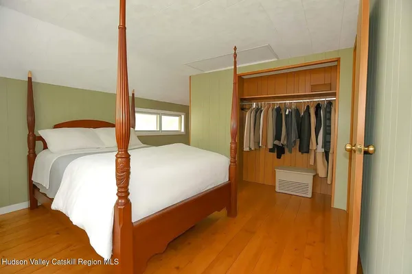 a bedroom with a bed and a mirror
