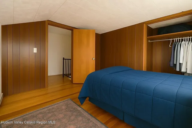 a bedroom with a bed and a walk in closet