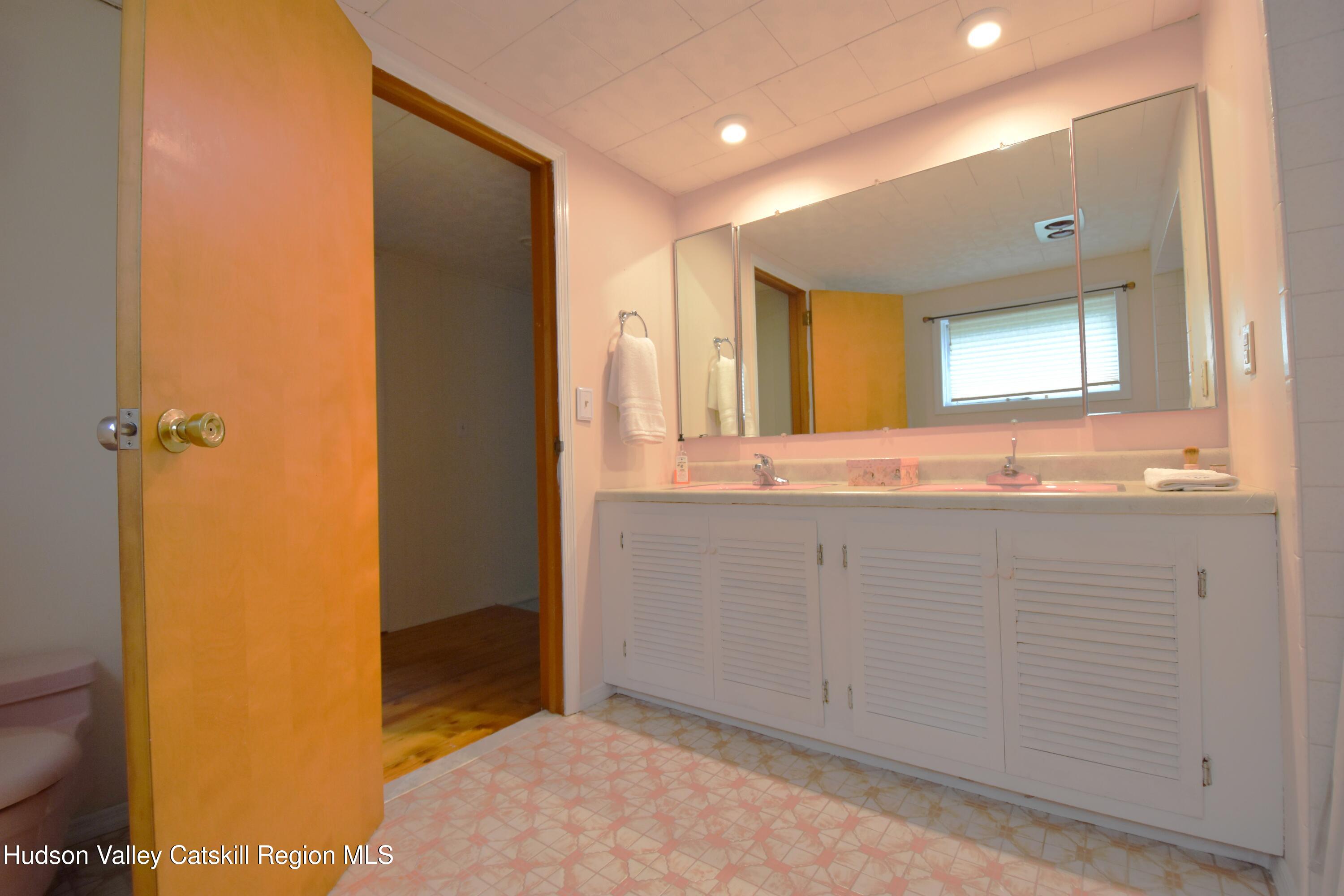 531 Old Post Road New Paltz, NY 12561 - Photo 20 of 25 a bathroom with a granite countertop sink and a mirror