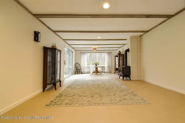 a view of a livingroom with wooden floor and a ceiling fan
