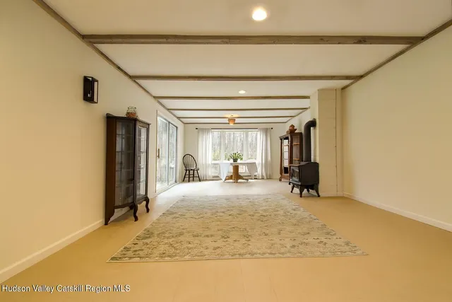 a view of a livingroom with wooden floor and a ceiling fan