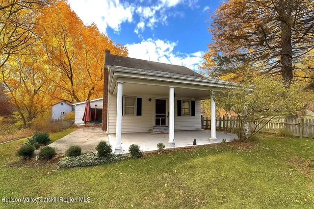a view of a house with backyard porch and sitting area