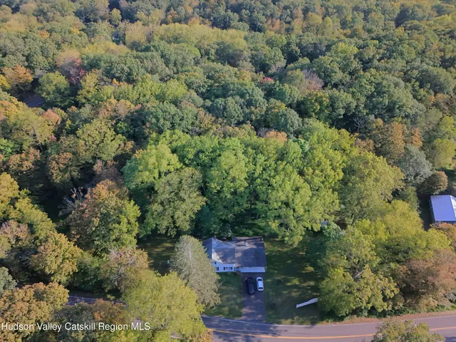 an aerial view of a house with a yard