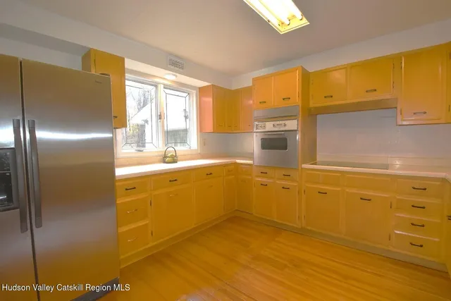 a spacious bathroom with a granite countertop shower a sink and a mirror