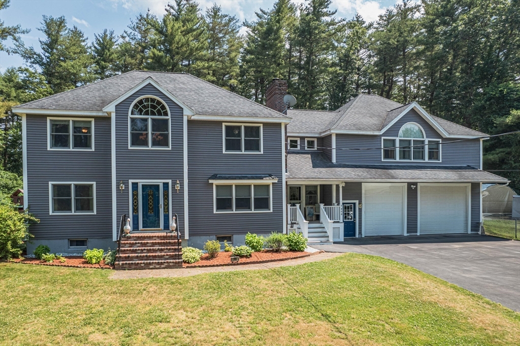 200 Boxford Road Rowley, MA 01969 - Photo 1 of 3 a front view of a house with a yard and garage