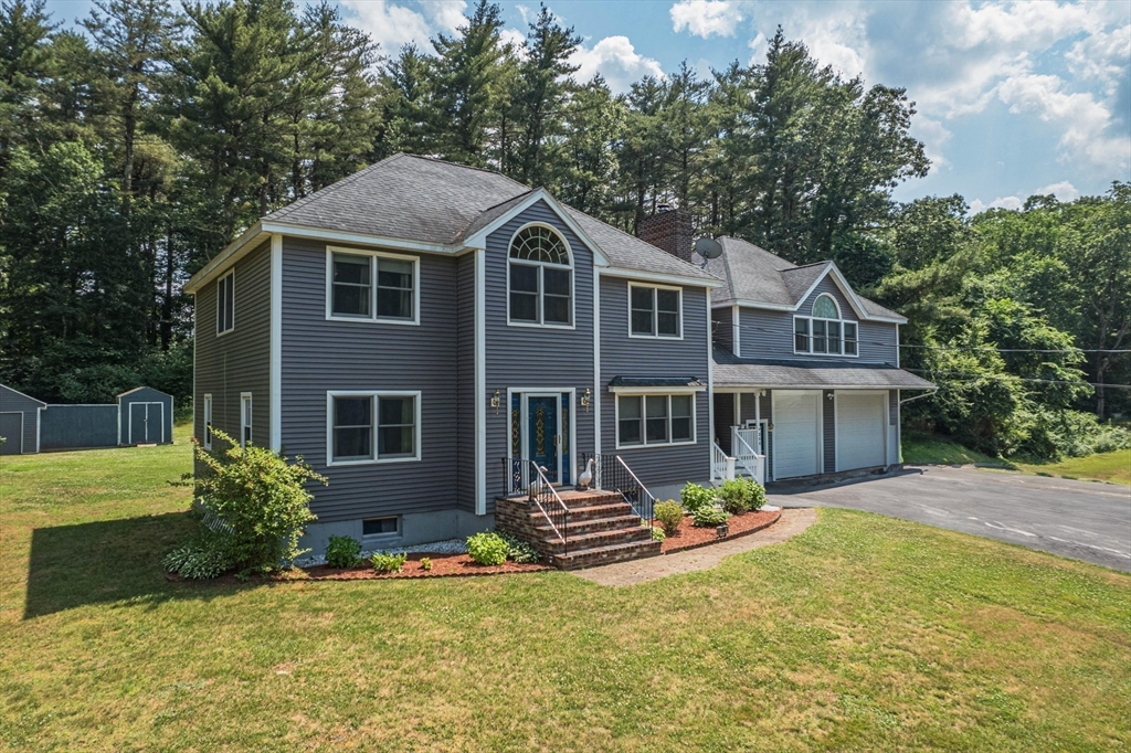 200 Boxford Road Rowley, MA 01969 - Photo 3 of 3 a front view of a house with a yard and garage