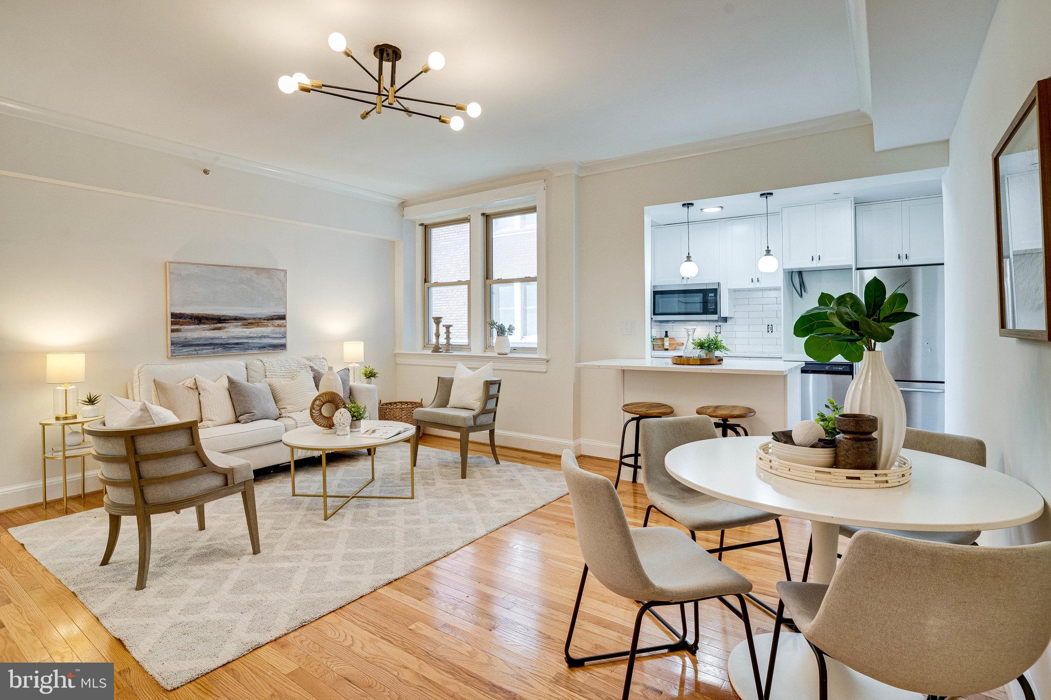 a dining room with furniture a window and wooden floor