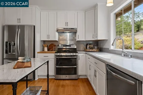 a kitchen with a sink stove and refrigerator