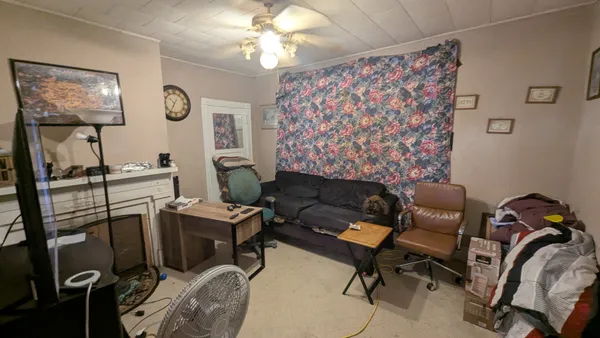 a work room with furniture and paintings on the wall