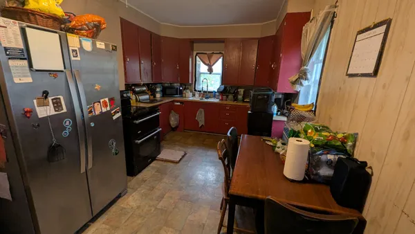 a kitchen with sink refrigerator and window
