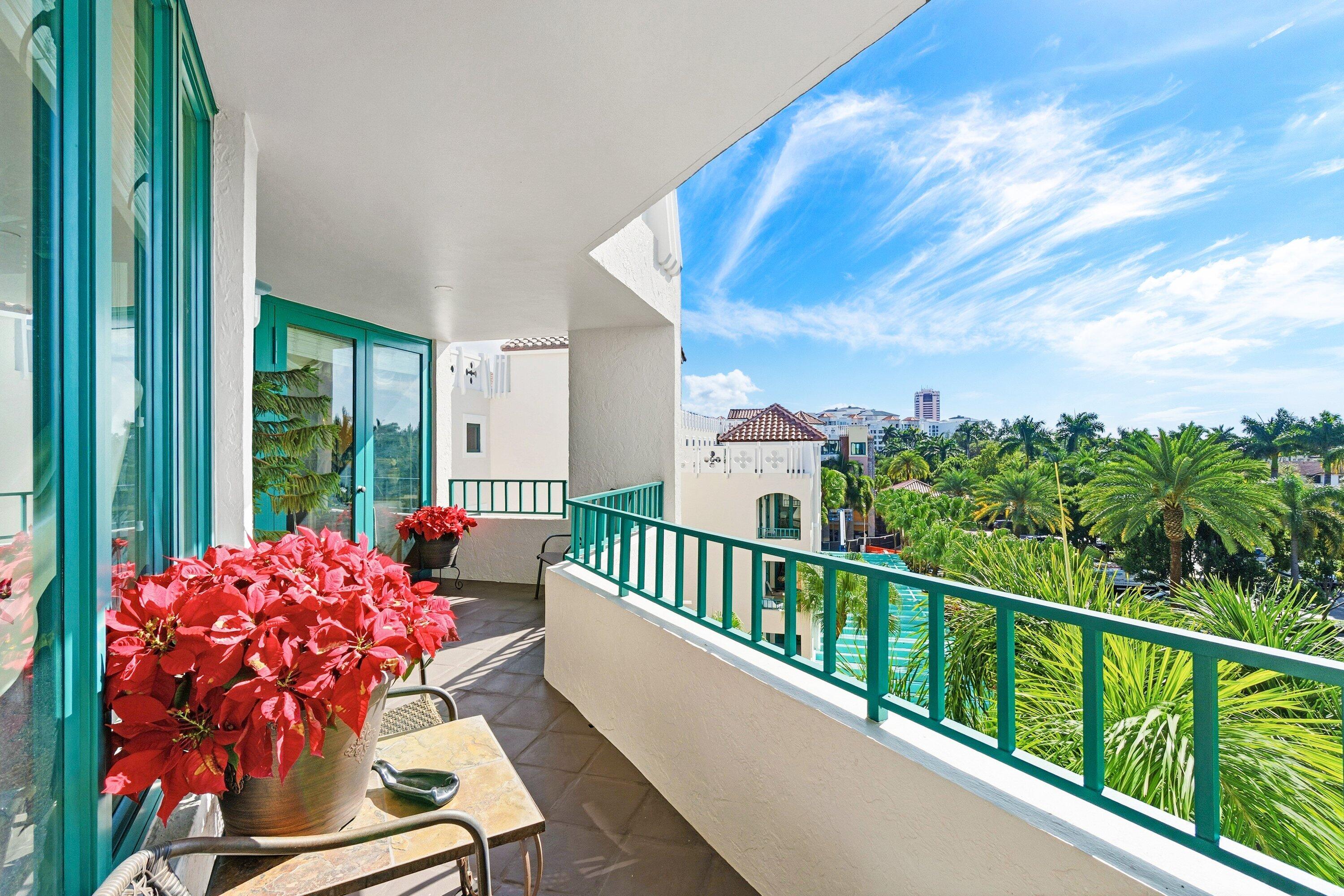 a balcony with wooden floor and outdoor seating