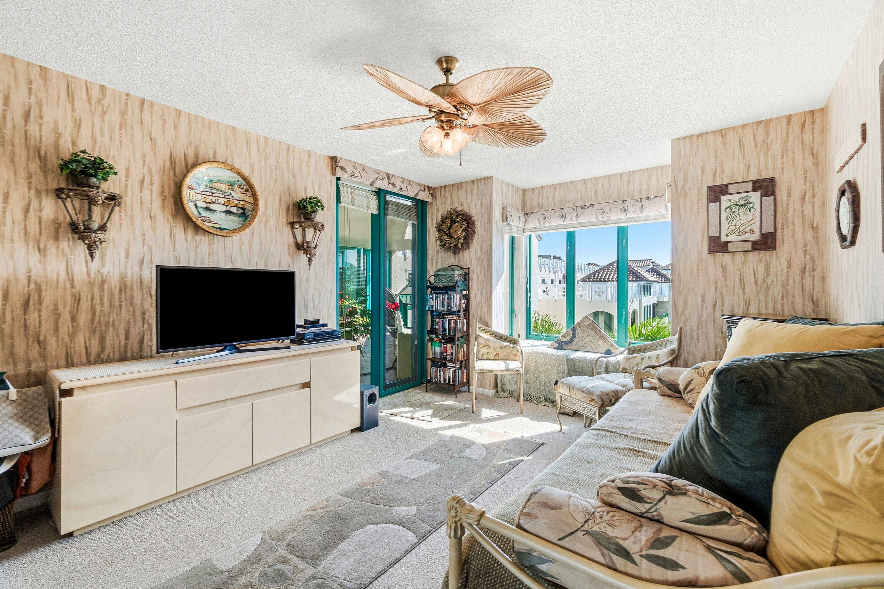 100 Southeast 5th Avenue, Unit PH14 Boca Raton, FL 33432 - Photo 14 of 49 a living room with furniture a flat screen tv and a window