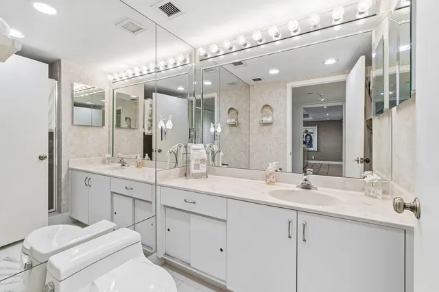a bathroom with a sink double vanity and a mirror