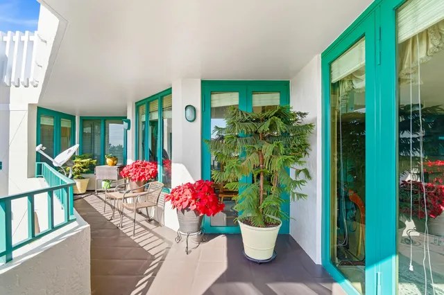 a view of a dining room with furniture and a potted plant