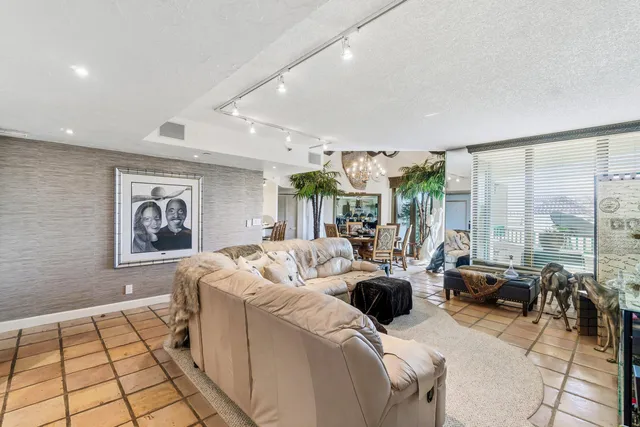 a living room with furniture and large windows