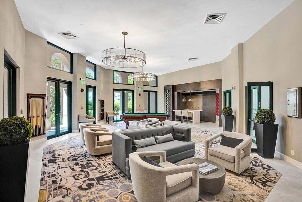 100 Southeast 5th Avenue, Unit PH14 Boca Raton, FL 33432 - Photo 42 of 49 a living room with furniture chandelier and a rug