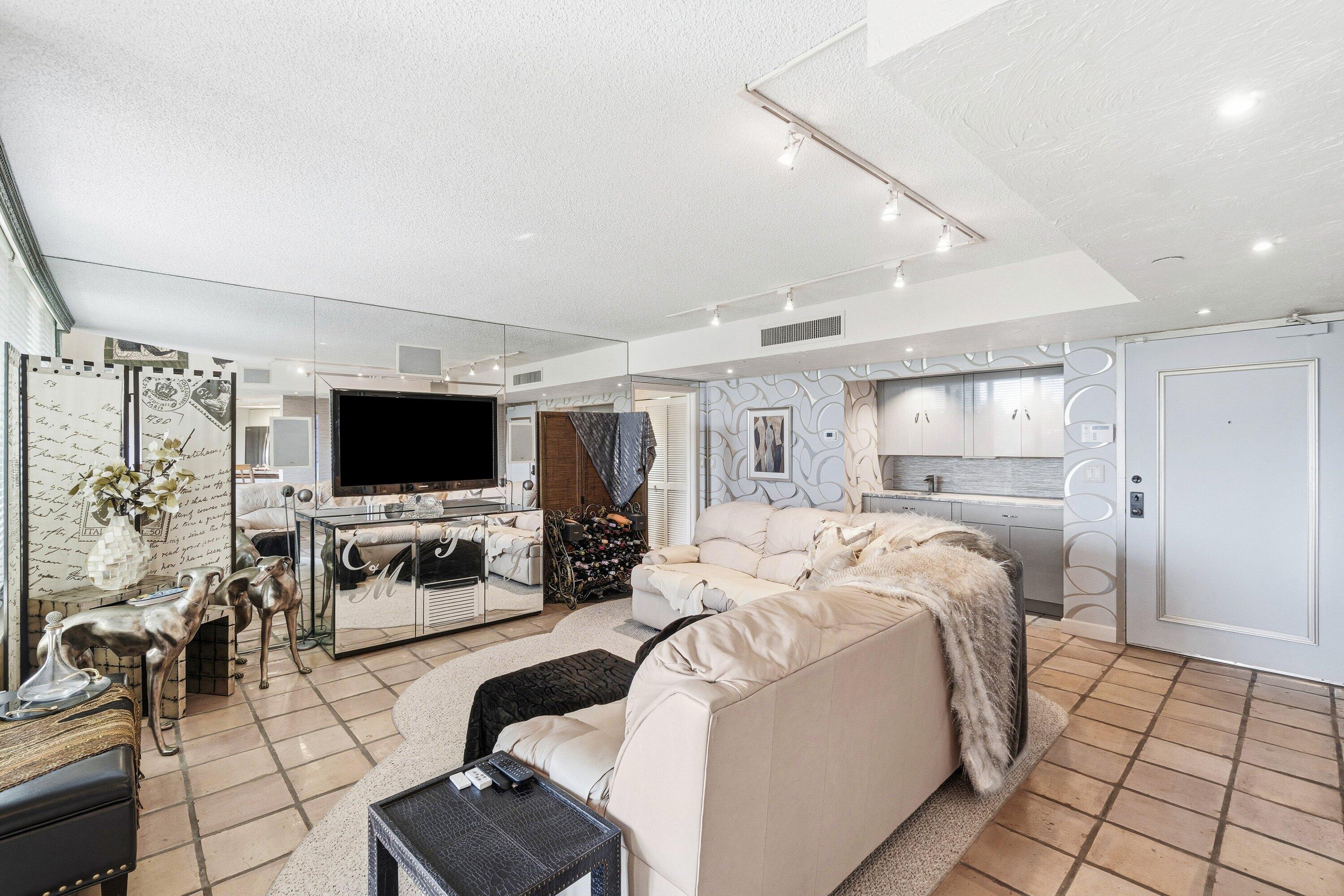 100 Southeast 5th Avenue, Unit PH14 Boca Raton, FL 33432 - Photo 5 of 49 a bedroom with bed a flat tv and a couch