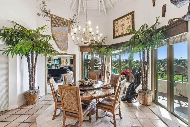 a view of a dining room with furniture a chandelier and window