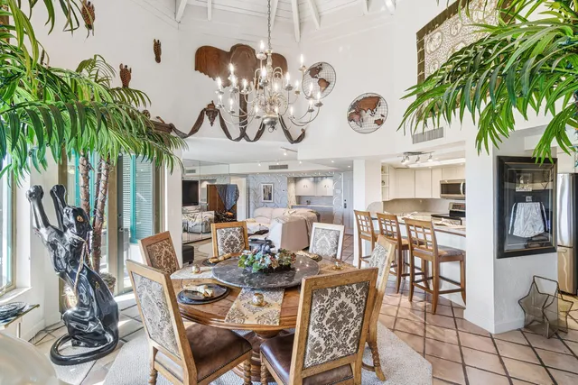 a view of a dinning room and livingroom with furniture wooden floor and a chandelier