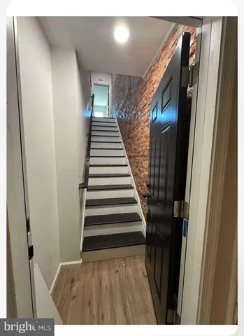 a view of entryway with stairs and wooden floor