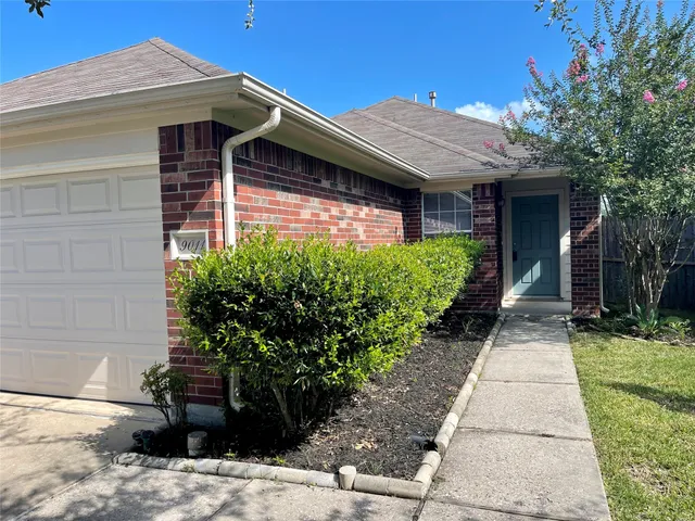 a front view of house with a garden