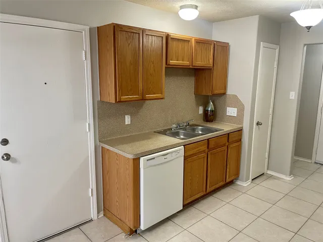 a kitchen with stainless steel appliances granite countertop a refrigerator and a stove