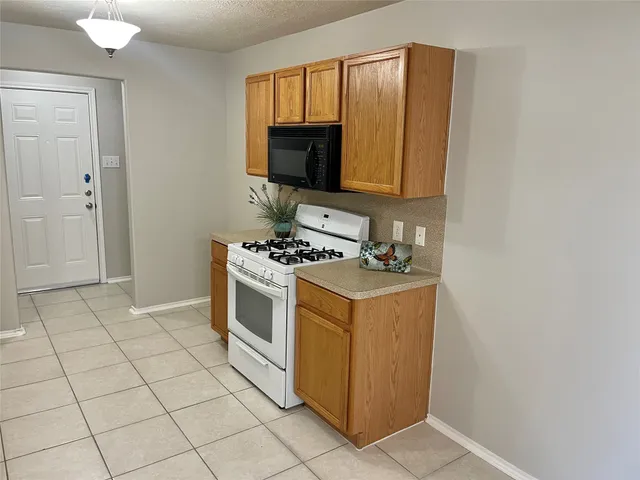 a kitchen with a stove a sink and a microwave