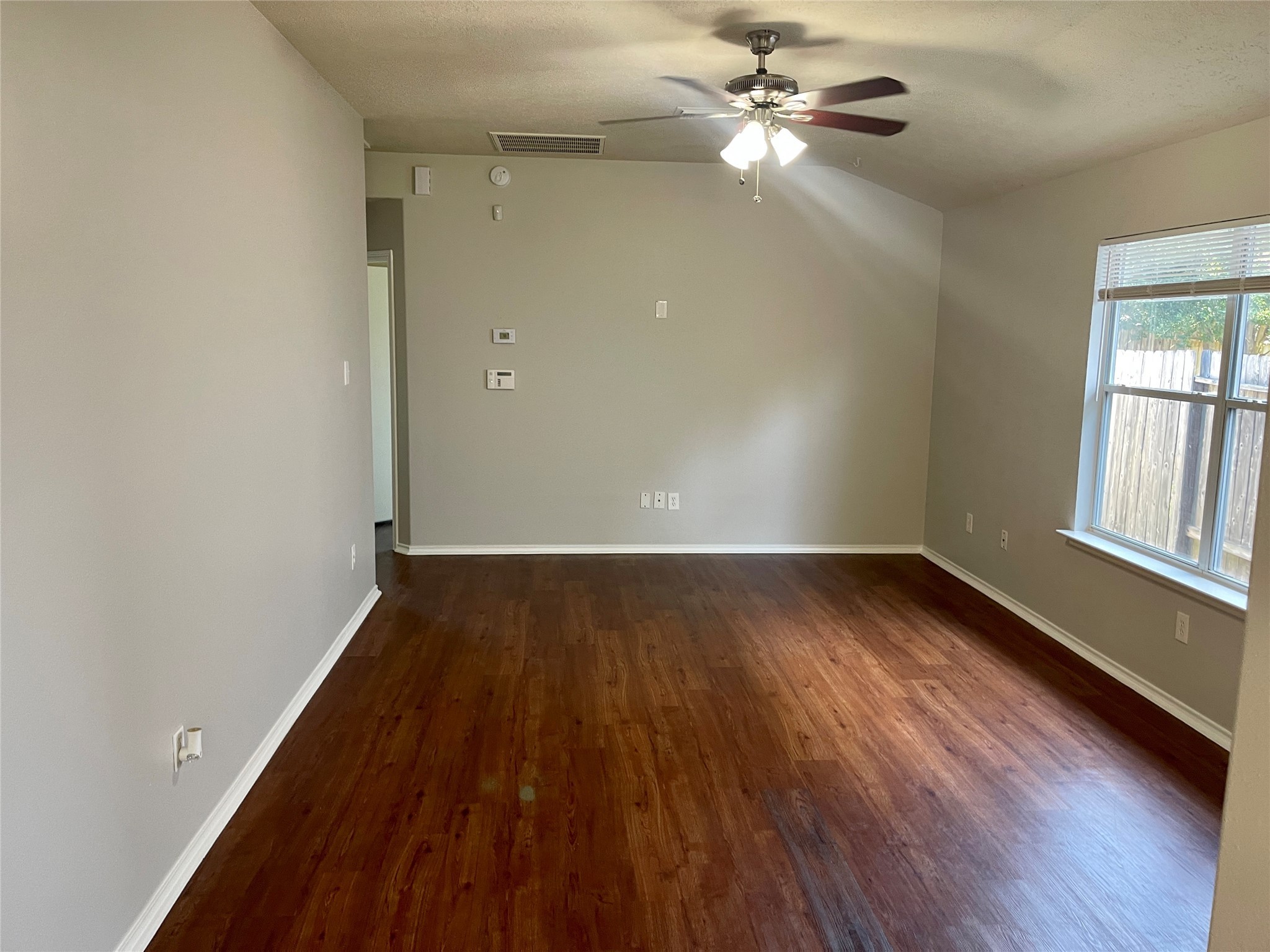 9011 Serena Lane Humble, TX 77338 - Photo 8 of 18 wooden floor in an empty room with a window