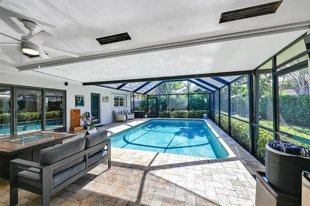 a room with pool table and windows