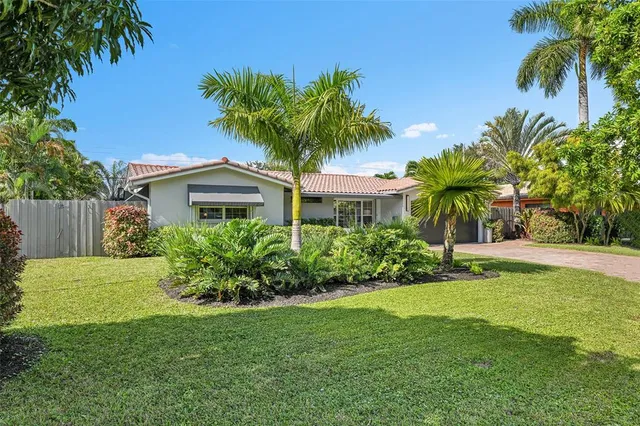 a front view of a house with a yard and a garage